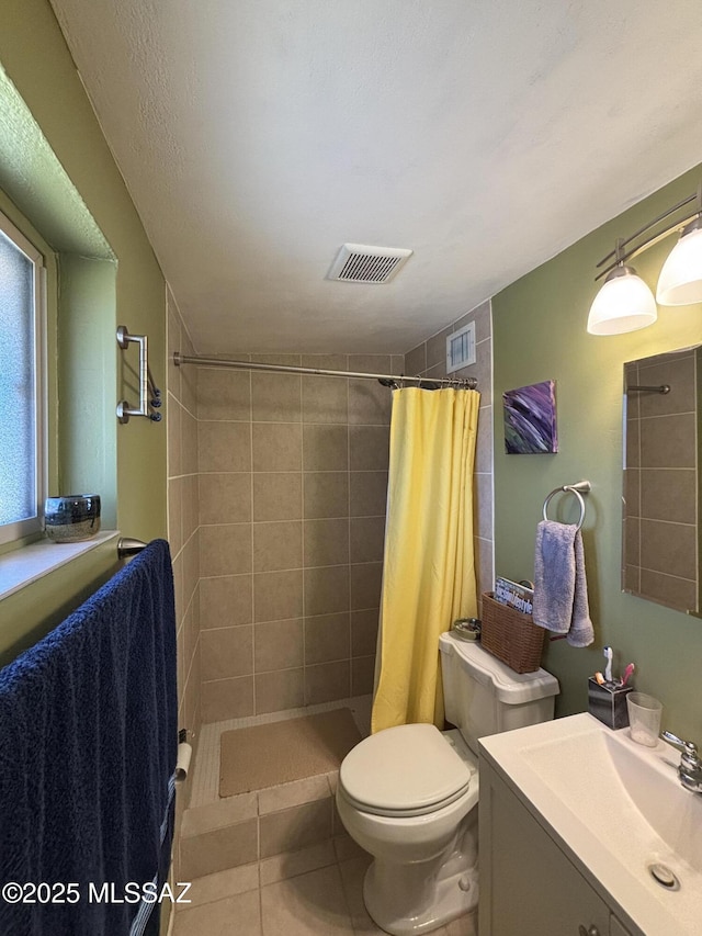 bathroom with tile patterned flooring, vanity, a shower with shower curtain, and toilet