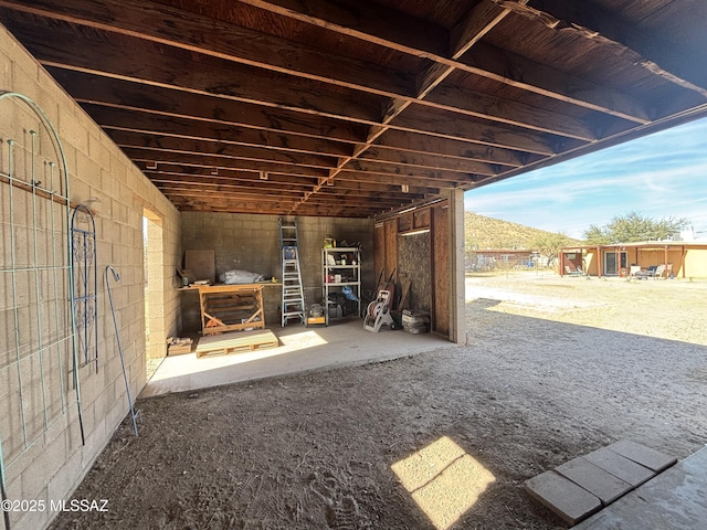 view of patio with a mountain view and an outdoor structure