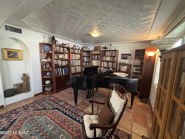 miscellaneous room featuring tile patterned flooring and a textured ceiling