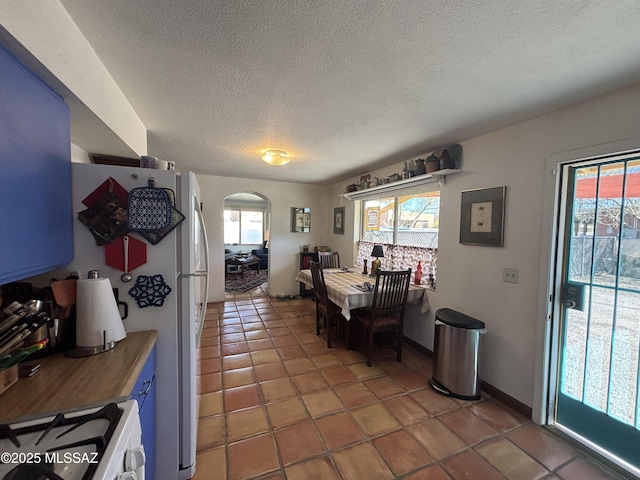 dining area with tile patterned flooring and a textured ceiling