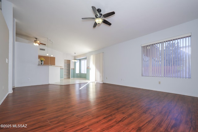 unfurnished living room featuring ceiling fan, lofted ceiling, and dark hardwood / wood-style flooring