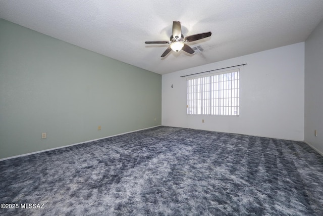 carpeted spare room with ceiling fan and a textured ceiling