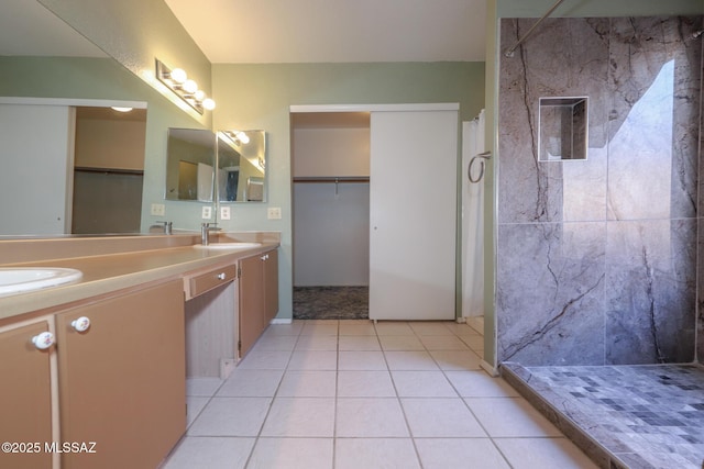 bathroom featuring tile patterned flooring, vanity, and curtained shower