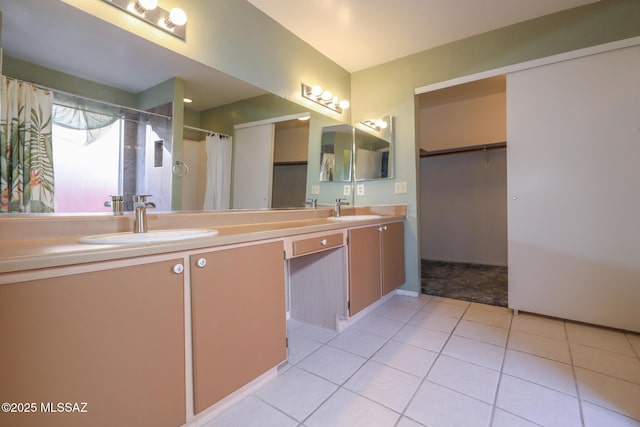 bathroom with tile patterned floors, curtained shower, and vanity