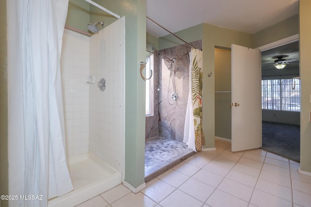 bathroom with curtained shower and tile patterned flooring