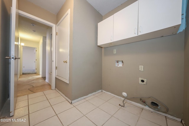 laundry room featuring cabinets, light tile patterned flooring, hookup for a washing machine, and hookup for an electric dryer