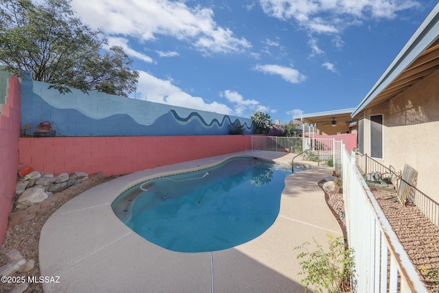 view of swimming pool with ceiling fan and a patio