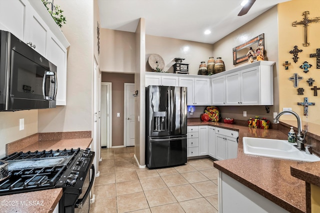 kitchen featuring white cabinetry, sink, light tile patterned floors, black fridge with ice dispenser, and gas stove