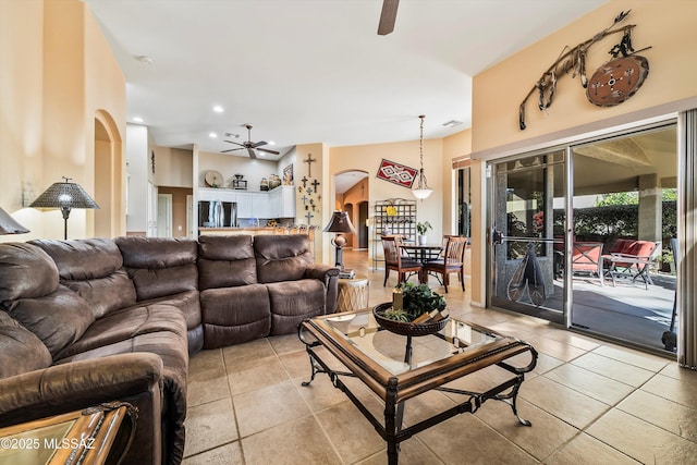 tiled living room with ceiling fan