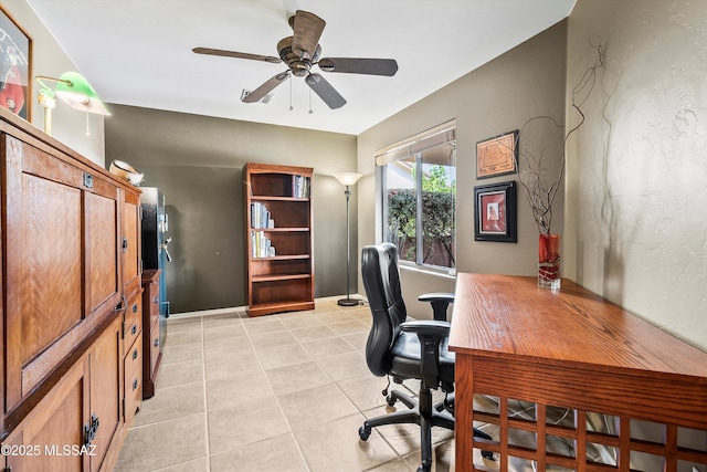 home office featuring light tile patterned flooring and ceiling fan