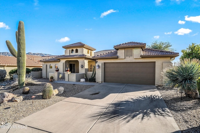 mediterranean / spanish home with a garage