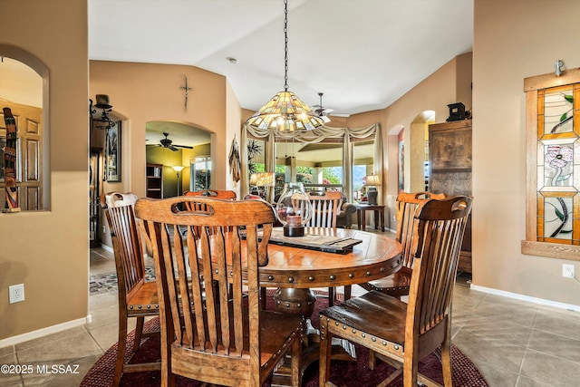 tiled dining area featuring lofted ceiling and ceiling fan