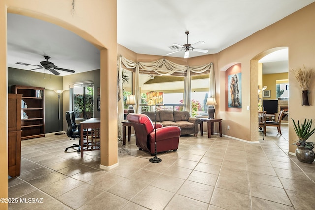 living room with light tile patterned floors and ceiling fan