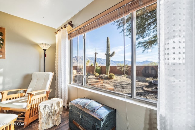 sitting room featuring a mountain view and dark hardwood / wood-style floors