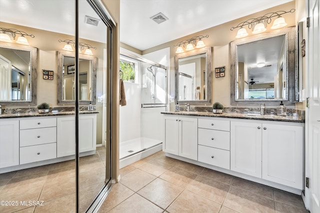 bathroom featuring an enclosed shower, vanity, and tile patterned flooring