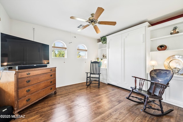 living area featuring dark hardwood / wood-style flooring and ceiling fan