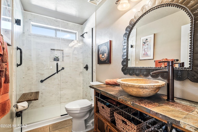 bathroom with vanity, toilet, and walk in shower