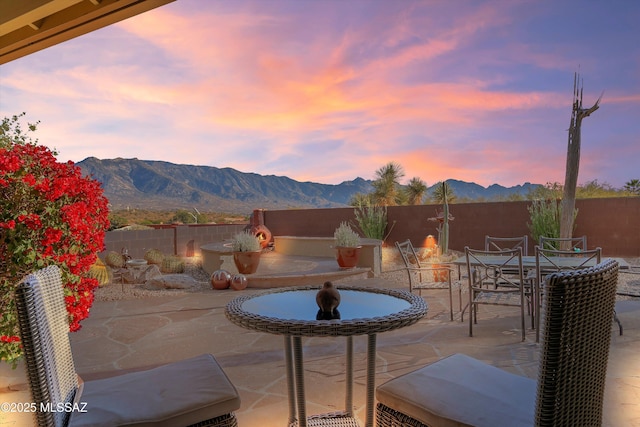 patio terrace at dusk with a mountain view