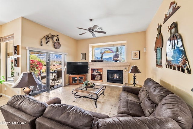 living room featuring ceiling fan and light tile patterned flooring