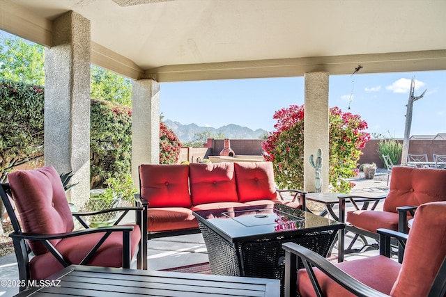 view of patio featuring an outdoor living space and a mountain view