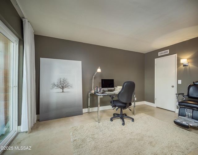 home office with concrete flooring