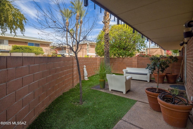 view of yard featuring an outdoor living space and a patio area