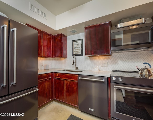 kitchen with tasteful backsplash, stainless steel appliances, and sink