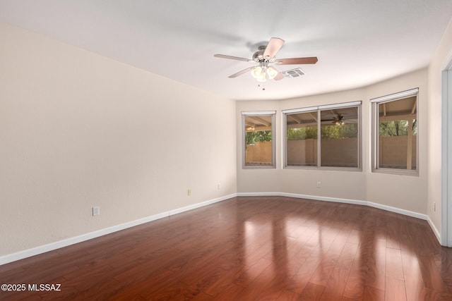 empty room featuring ceiling fan and dark hardwood / wood-style floors