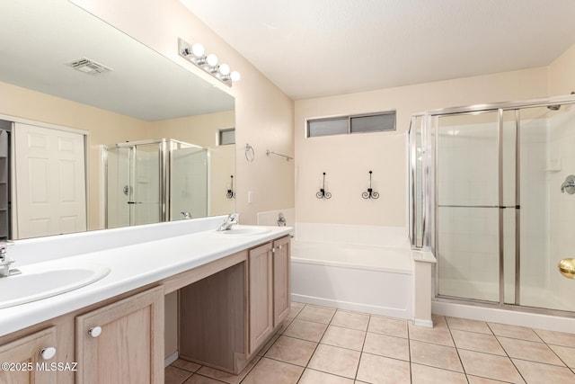 bathroom featuring tile patterned floors, independent shower and bath, and vanity