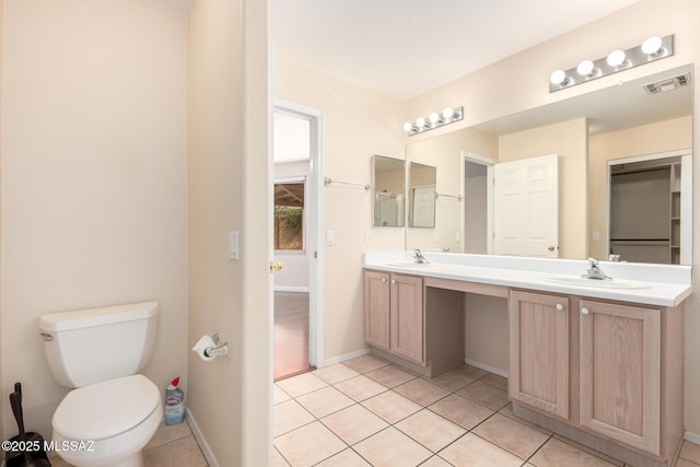 bathroom with vanity, toilet, and tile patterned flooring