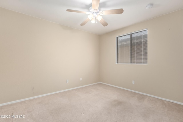 empty room featuring ceiling fan and light carpet