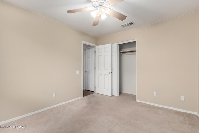 unfurnished bedroom featuring light carpet, ceiling fan, and a closet