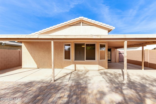 back of house with a patio