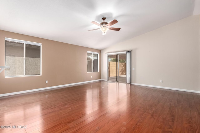 spare room with dark wood-type flooring, ceiling fan, and lofted ceiling