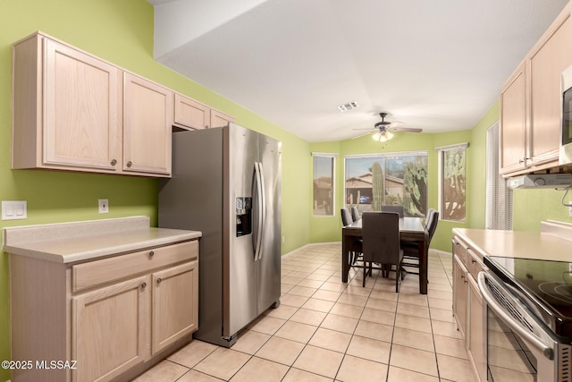 kitchen featuring appliances with stainless steel finishes, light brown cabinets, ceiling fan, and light tile patterned floors