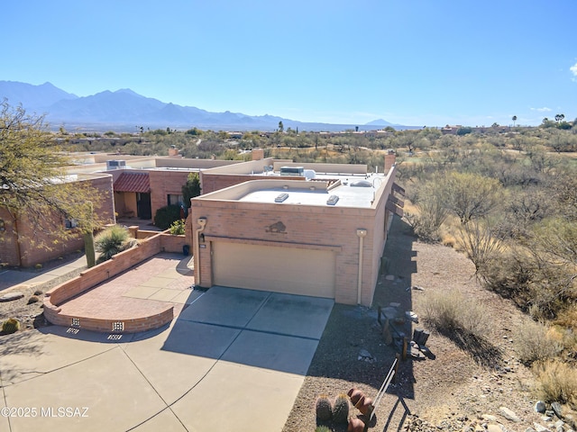 view of front of house with a mountain view and a garage