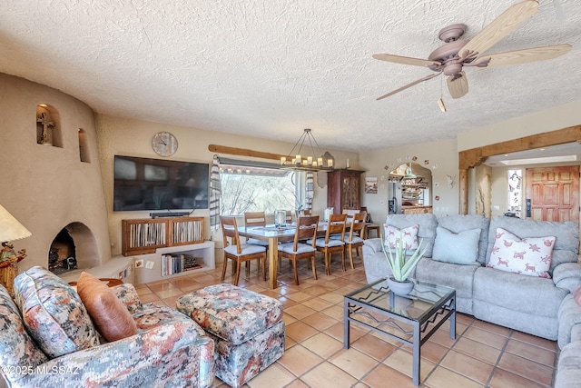 tiled living room featuring ceiling fan with notable chandelier and a textured ceiling