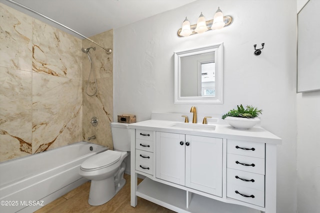 full bathroom featuring vanity, tiled shower / bath combo, and toilet