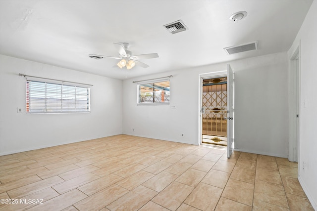 spare room with plenty of natural light and ceiling fan