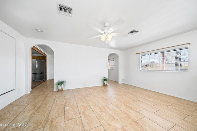 spare room with light wood-type flooring and ceiling fan