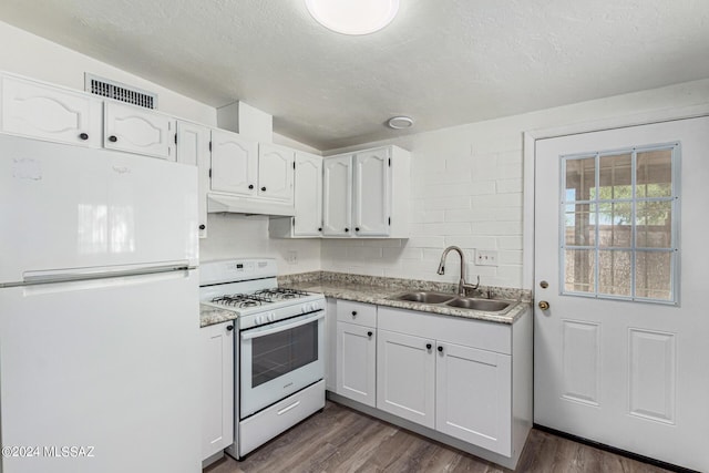 kitchen featuring sink, white appliances, dark wood-type flooring, and white cabinets