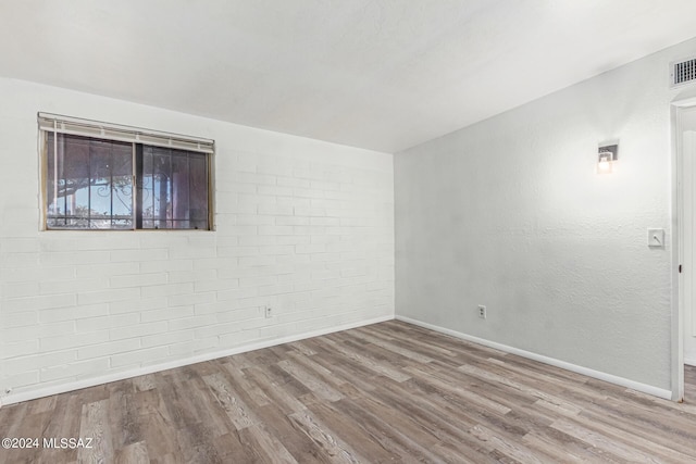 spare room with light hardwood / wood-style flooring