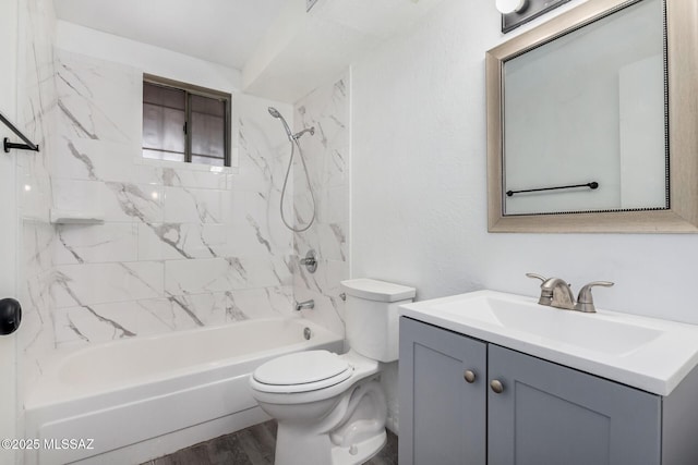 full bathroom featuring vanity, toilet, tiled shower / bath combo, and wood-type flooring