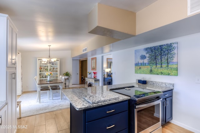 kitchen featuring white cabinetry, blue cabinets, light stone counters, and stainless steel electric range