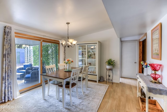 dining room featuring a chandelier and light hardwood / wood-style flooring