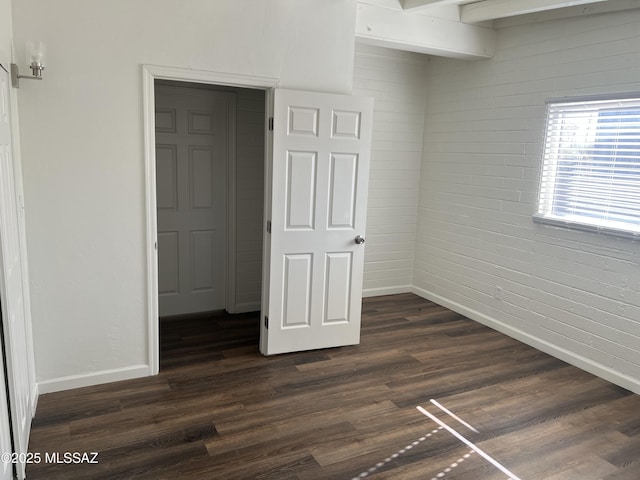 unfurnished bedroom featuring dark hardwood / wood-style floors