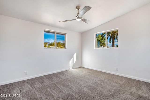 unfurnished room with ceiling fan, lofted ceiling, and carpet