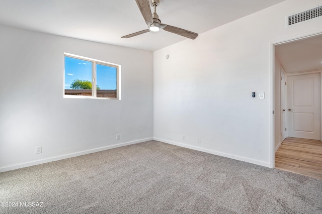 spare room featuring carpet floors and ceiling fan