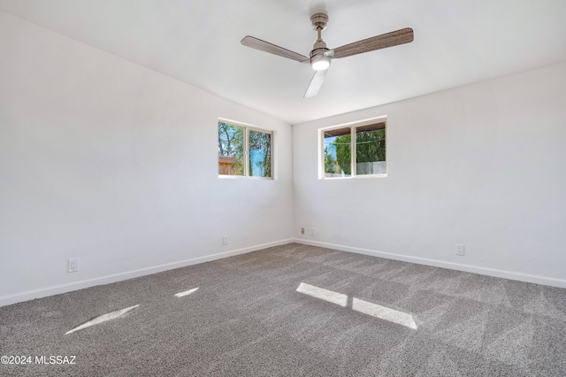 carpeted spare room with ceiling fan and lofted ceiling