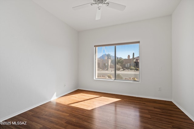 spare room featuring ceiling fan and dark hardwood / wood-style floors